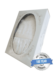White formal garment in a decorative box with a "100 Year Anti-Yellowing Guarantee" badge on the lower right corner.